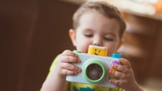 A boy plays with a toy on his adoption day