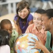 Children and teacher discussing adoption at school