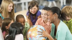 Children and teacher discussing adoption at school