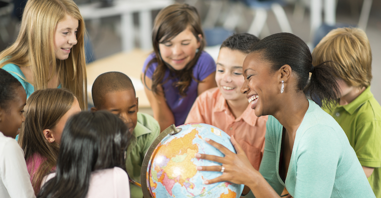 Children and teacher discussing adoption at school