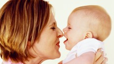 A mother observing her baby for developmental milestones