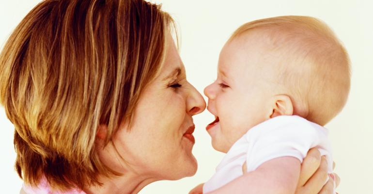 A mother observing her baby for developmental milestones