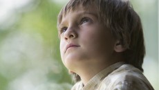 A young boy pondering questions about birth siblings