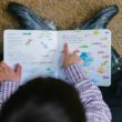 A boy reads an adoption children's book