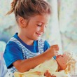 A young girl engages in pretend play