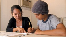 A teen works with a tutor to overcome learning problems