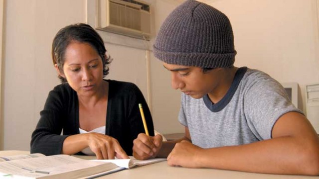 A teen works with a tutor to overcome learning problems