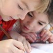 Two girls work together on a project during adoption classes.