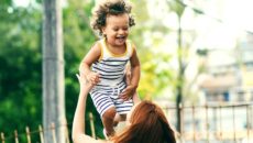 A woman plays with her child after sharing her adoption decision with her family