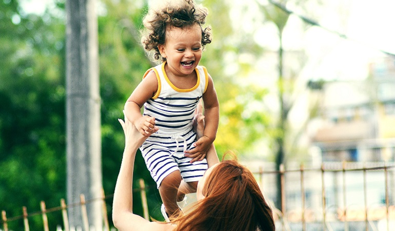 A woman plays with her child after sharing her adoption decision with her family