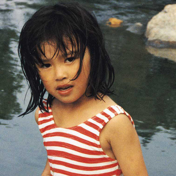 A child brought home via international adoption, plays on the beach