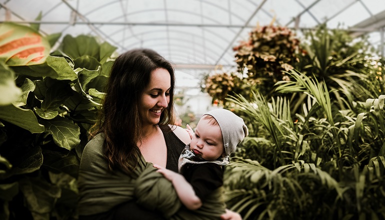 An adoptive mom using a baby carrier