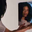 A preteen looks in the mirror as she wrestles with identity struggles