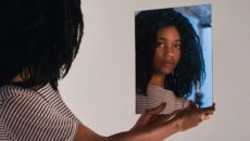 A preteen looks in the mirror as she wrestles with identity struggles