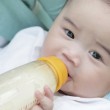 Picture of someone feeding their baby close to them, one of the ways to bond