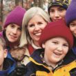 Susan Belfiore with her family that she met as an orphanage volunteer before becoming their adoptive mother.