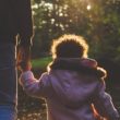 A dad walks in the forest with his daughter after adopting after age 50.