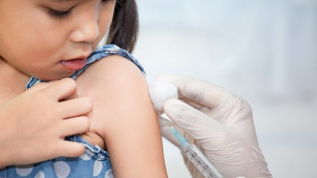 An Asian child undergoes TB tests before coming to the United States