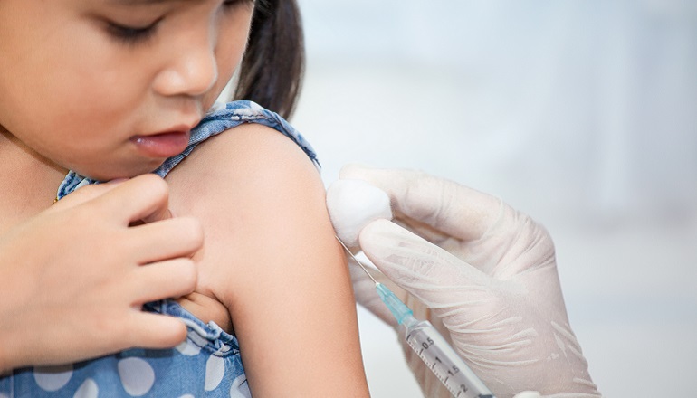 An Asian child undergoes TB tests before coming to the United States