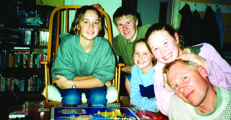 Group of siblings, several in their teen years, and father