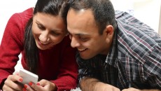 A couple investigating some of the best apps for adoptive parents