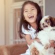 A girl laughs at her mom telling jokes for bonding with her child.