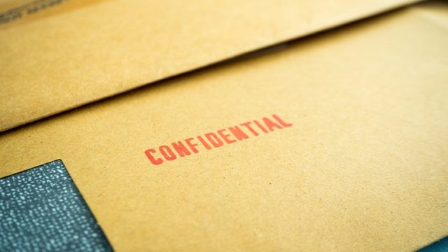 A file stamped, "Confidential" represents closed adoption records.
