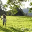 Family walking up a grassy hill together having a talk about adoption