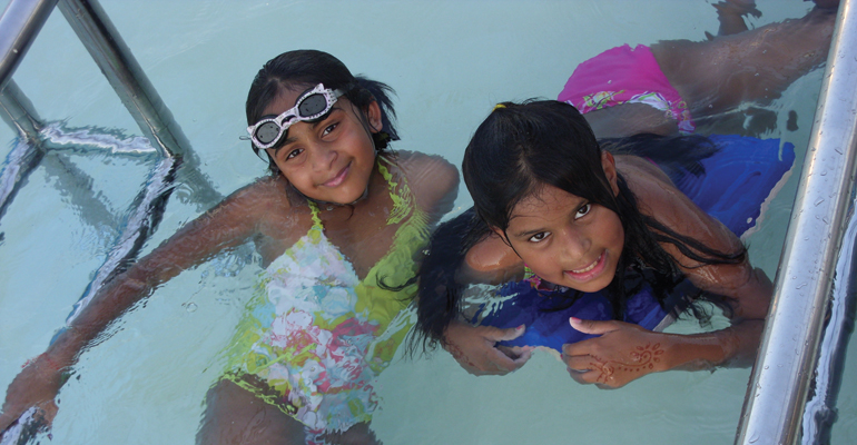 The author's daughter, Tess, swimming with a friend at her yearly India Camp