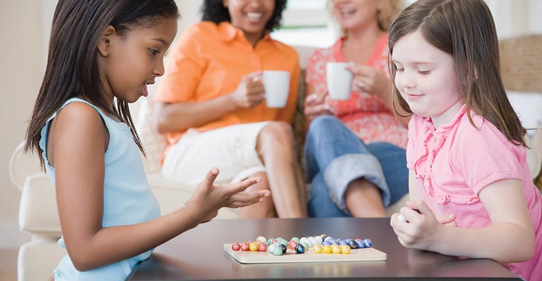 Two children playing a game, showcasing friendship skills in adopted children