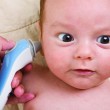 Testing a baby for vision and hearing problems