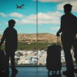 A mother and her kids at the airport, leaving for a heritage travel trip.