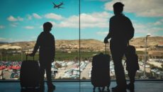 A mother and her kids at the airport, leaving for a heritage travel trip.