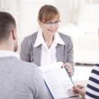 A couple talking to an adoption professional