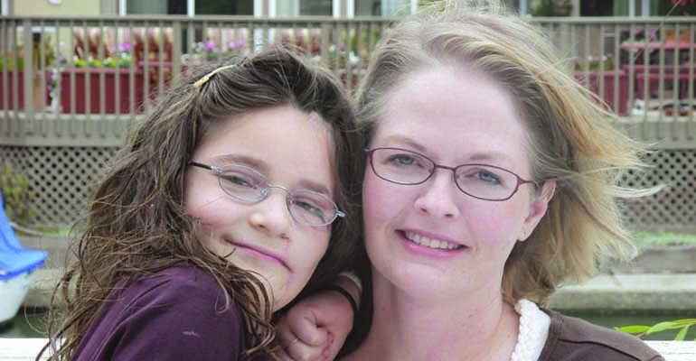 Anastasia, after her surgery to repair her facial burns, with her mother