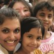 A woman embraces three children on a heritage travel trip to India