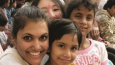 A woman embraces three children on a heritage travel trip to India