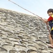 A resilient child overcoming a rock climbing course