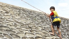 A resilient child overcoming a rock climbing course