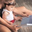 A mom works on language skills by reading with her child.