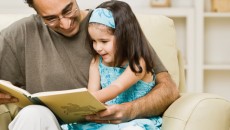 Father reading with his daughter to ward off language impairment
