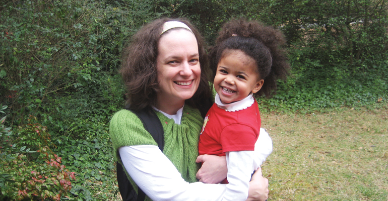 Patti Ghezzi and her daughter, a black baby with natural hair