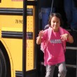 A child getting off a school bus, prepared to discuss race in the classroom