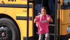 A child getting off a school bus, prepared to discuss race in the classroom