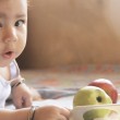 Baby with apples, symbolizing adoptive nutrition