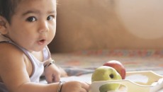 Baby with apples, symbolizing adoptive nutrition
