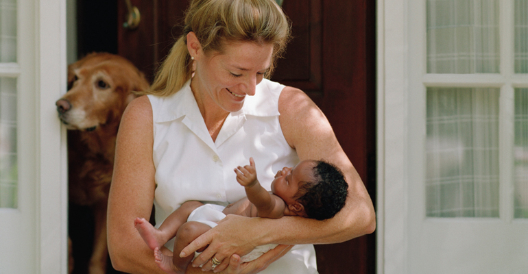 An adoptive mother preparing pet for a new baby