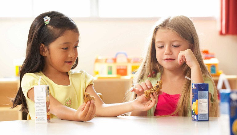 A picky eater shares her school lunch with a friend