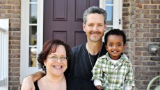 A family sitting together happily after accepting an adoption referral