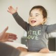 A smiling baby, progressing through the stages of infant development